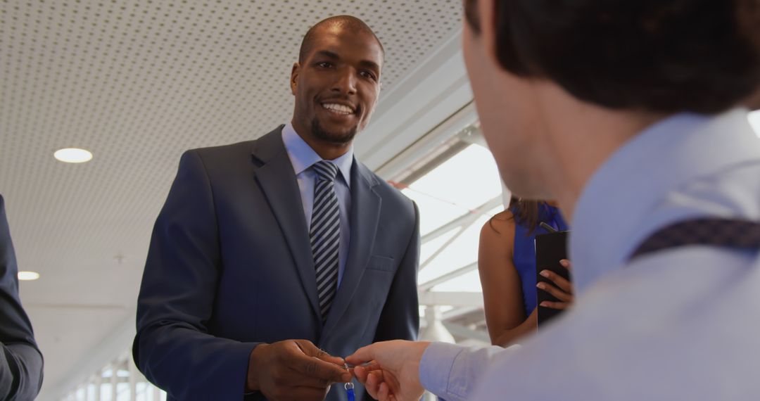 Businessman Exchanging Contact Information at Professional Event - Free Images, Stock Photos and Pictures on Pikwizard.com