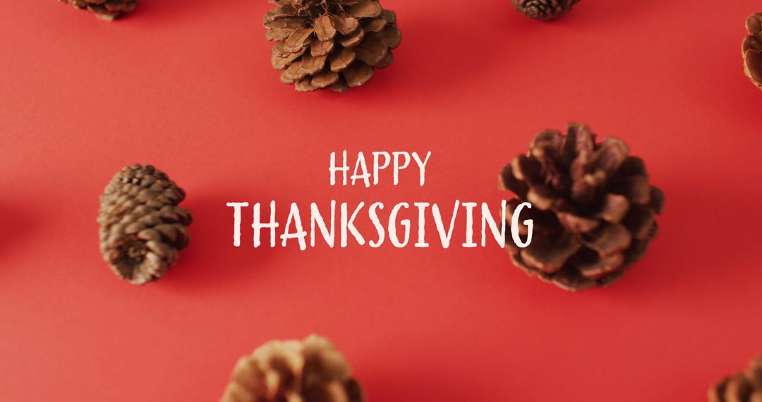 Happy Thanksgiving Greeting with Pine Cones on Red Background