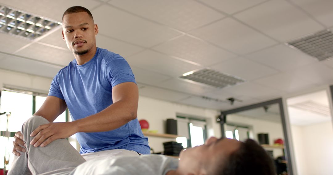 Physiotherapist Assisting Patient with Leg Exercises in Rehab Session