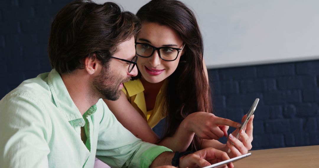 Colleagues Collaborating on Smartphone at Modern Office