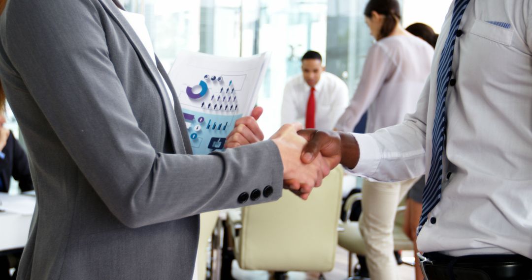 Businesspeople Shaking Hands in Modern Office Meeting - Free Images, Stock Photos and Pictures on Pikwizard.com