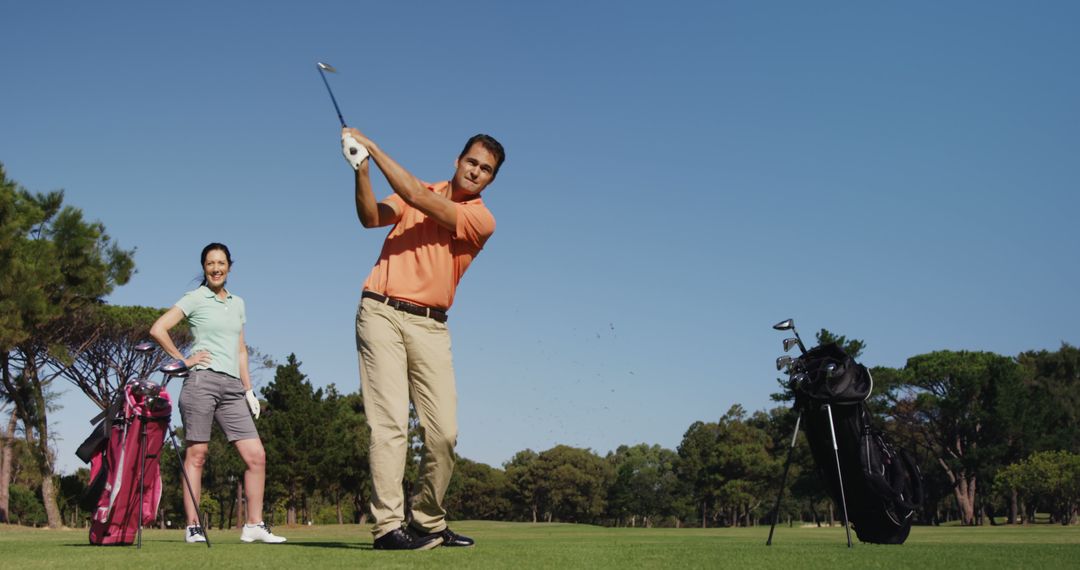 Professional Golfers Practicing on Scenic Course