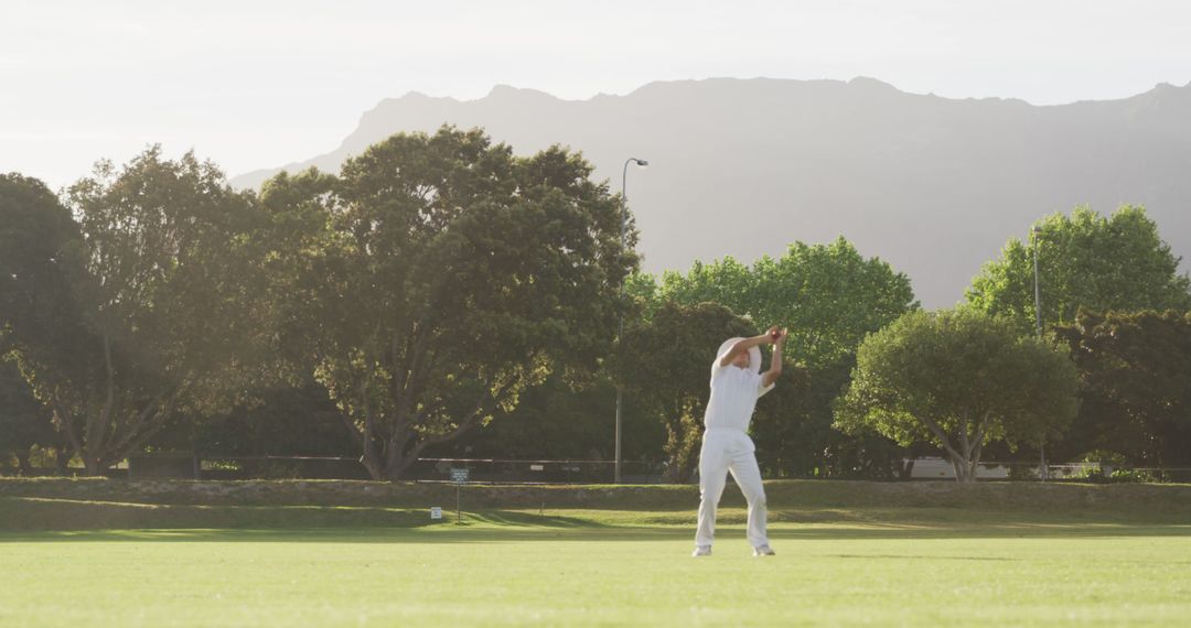 Cricket Player in Action Position Field Suburban Landscape