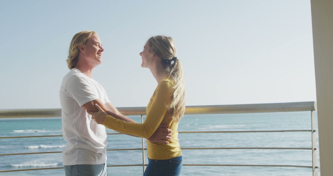 Happy Couple Embracing on Beach Balcony with Ocean View - Free Images, Stock Photos and Pictures on Pikwizard.com