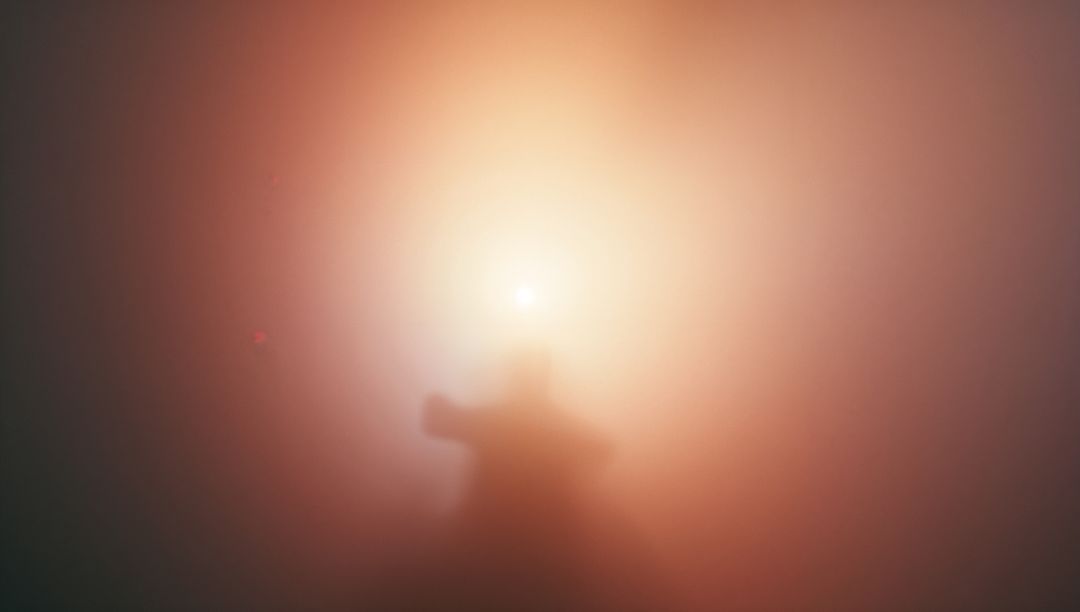 Backlit silhouetted figure reaching through fog toward glowing halo, minimal abstract