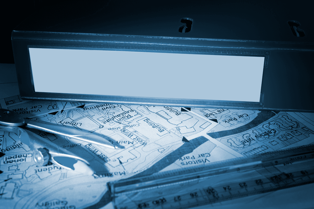 Transparent Blue Binder on Desk with Map and Compass