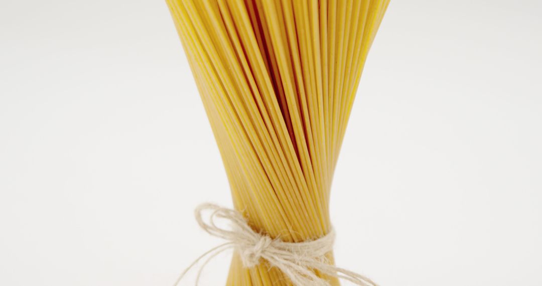 Bundle of Uncooked Spaghetti Tied with String - Free Images, Stock Photos and Pictures on Pikwizard.com