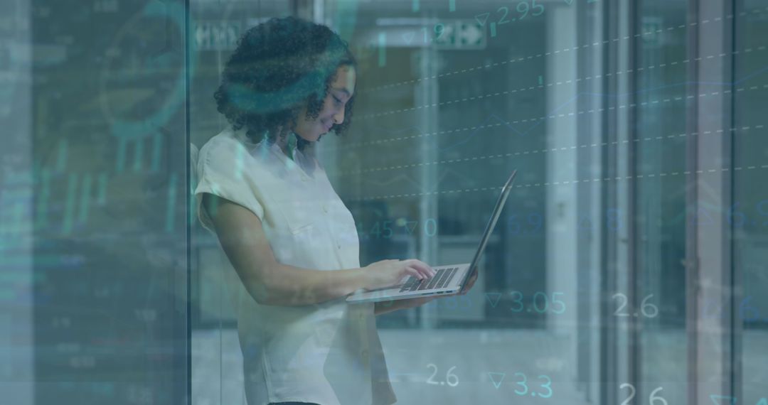 Focused Woman Analyzing Data with Laptop in Modern Office