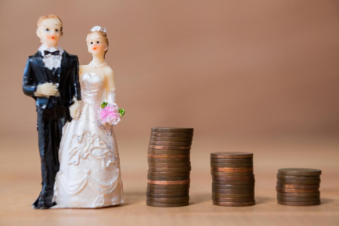 Miniature Bridal Couple with Stacked Coins Symbolizing Wedding Costs - Free Images, Stock Photos and Pictures on Pikwizard.com