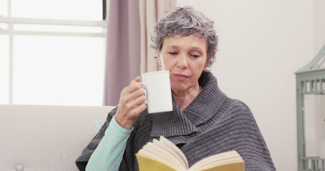 Senior Woman Relaxing with Coffee and Book at Home - Free Images, Stock Photos and Pictures on Pikwizard.com