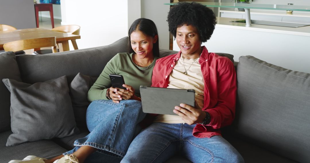 Diverse Couple Enjoying Technology on Cozy Couch