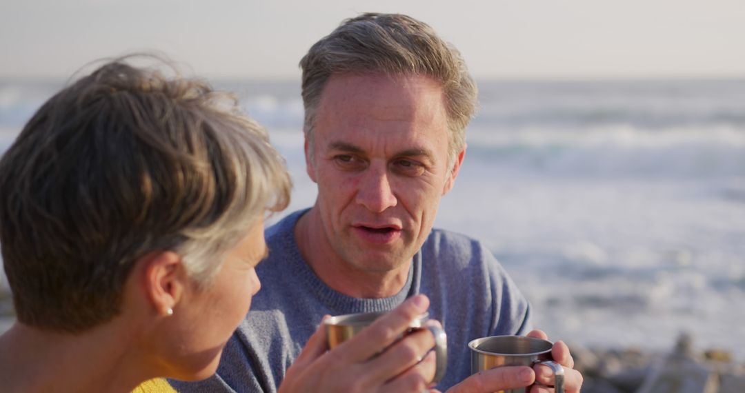 Middle Aged Couple Enjoying Coffee at the Beach - Free Images, Stock Photos and Pictures on Pikwizard.com