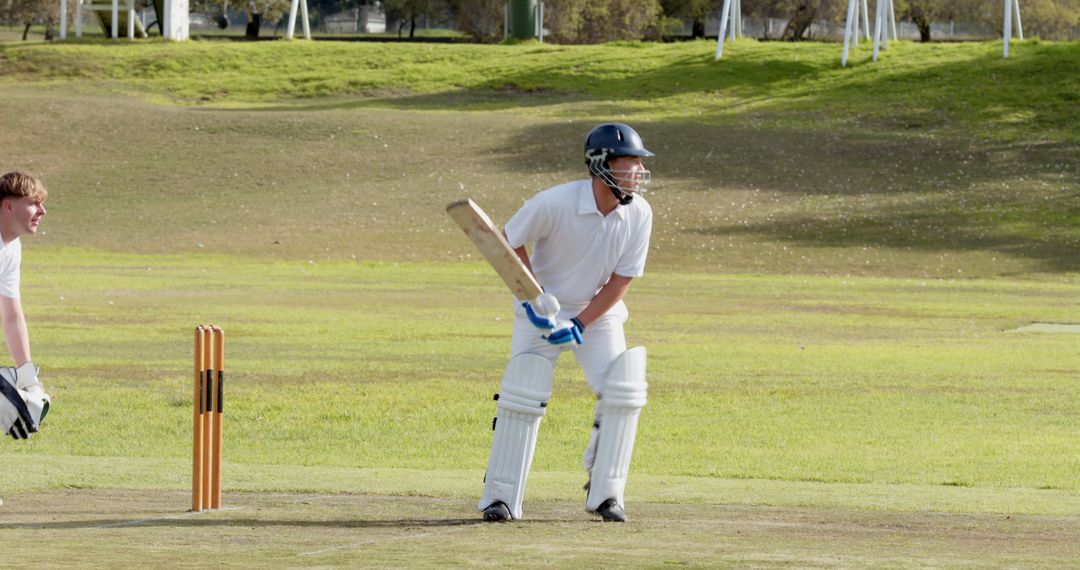 Cricketer Performs Battling Technique on Sunny Sports Field
