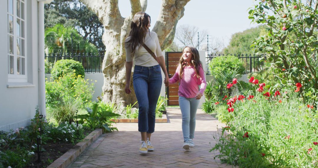 Mother and Daughter Walking in Garden Holding Hands - Free Images, Stock Photos and Pictures on Pikwizard.com