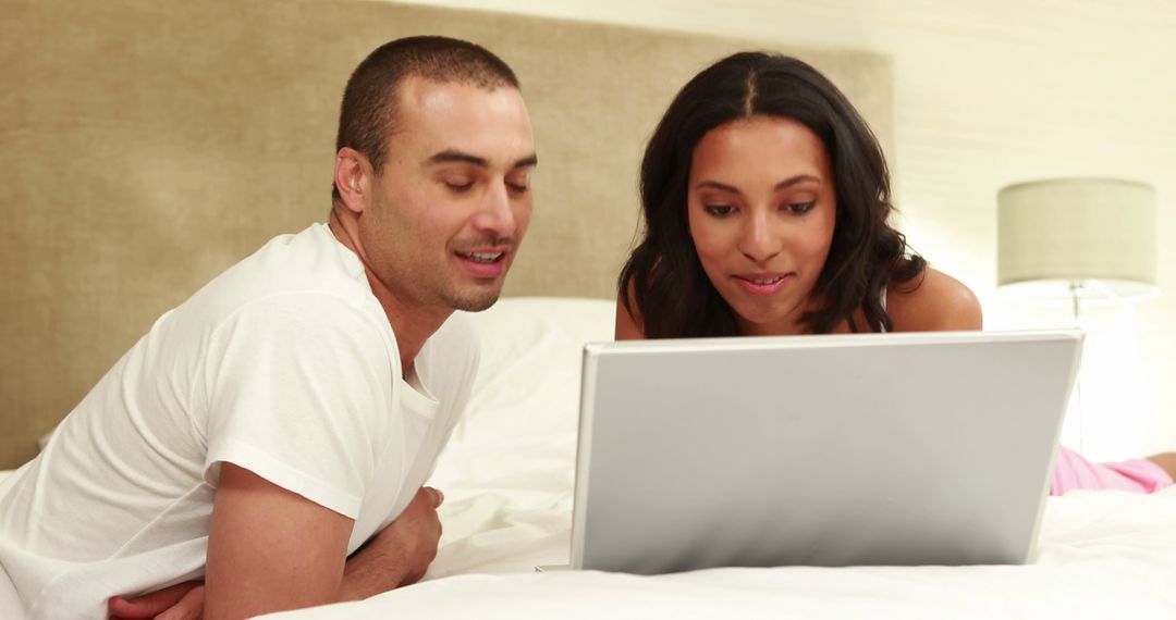 Couple Using Laptop Together in Cozy Bedroom Environment - Free Images, Stock Photos and Pictures on Pikwizard.com