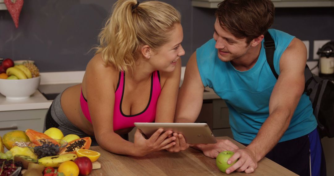 Active Couple Exploring Health Tips Together in Kitchen