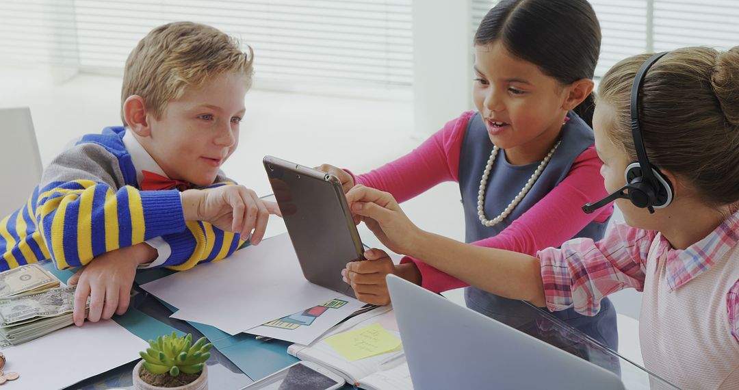 Children Engaging in Business with Tablet and Headset at Office Desk - Free Images, Stock Photos and Pictures on Pikwizard.com