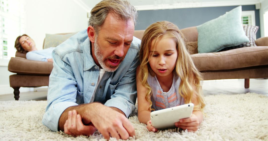 Father and Daughter Enjoying Leisure Time with Tablet on Floor - Free Images, Stock Photos and Pictures on Pikwizard.com