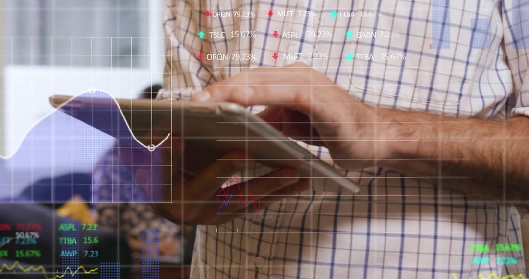 Businessman Uses Tablet for Financial Data Analysis in Office
