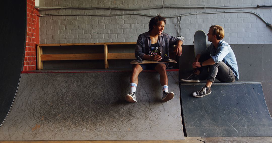 Two Friends Chatting in Skatepark Indoor Setting - Free Images, Stock Photos and Pictures on Pikwizard.com