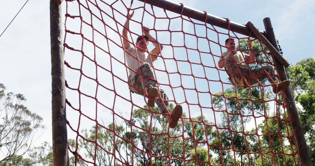 Two Boys Climbing Rope Net on Outdoor Obstacle Course - Free Images, Stock Photos and Pictures on Pikwizard.com