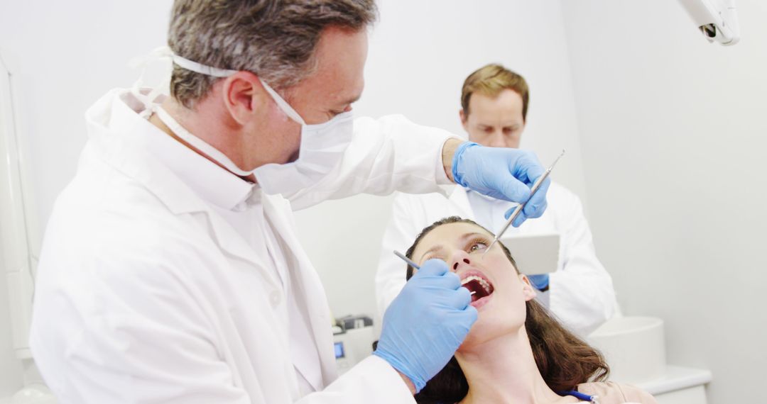 Female Patient Receiving Dental Treatment from Professional Dentist - Free Images, Stock Photos and Pictures on Pikwizard.com