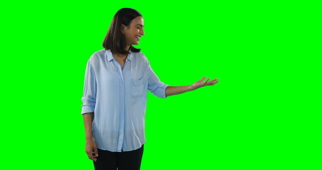 A young Asian woman appears as a welcoming presenter against a green screen backdrop. - Free Images, Stock Photos and Pictures on Pikwizard.com