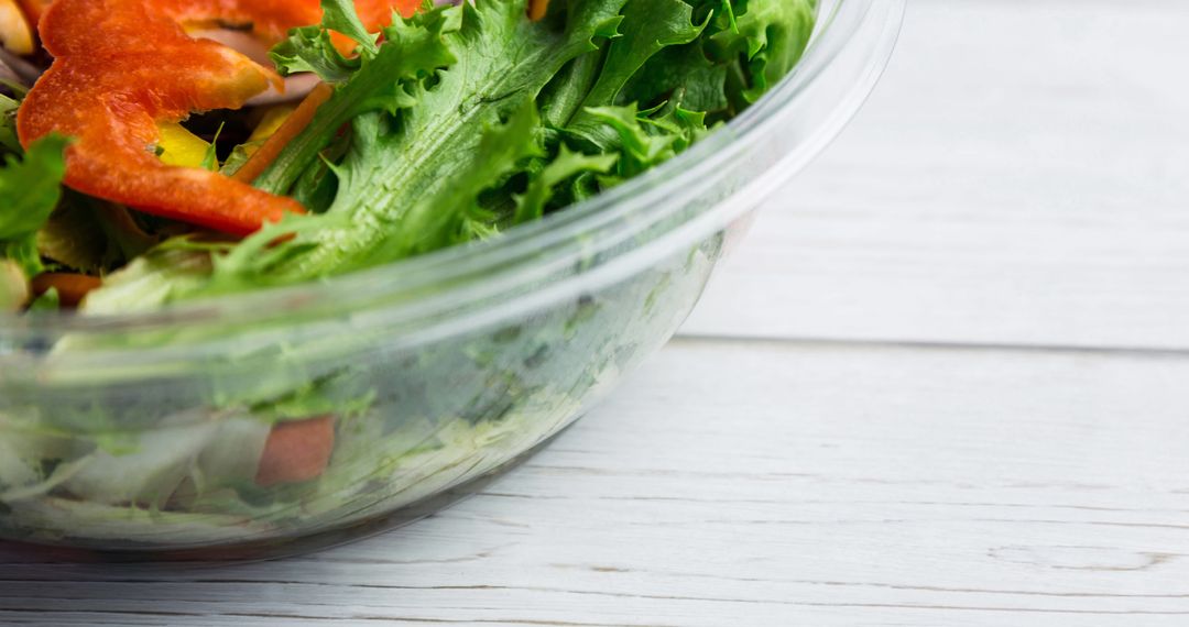 Fresh Vegetable Salad in Glass Bowl on Wooden Surface