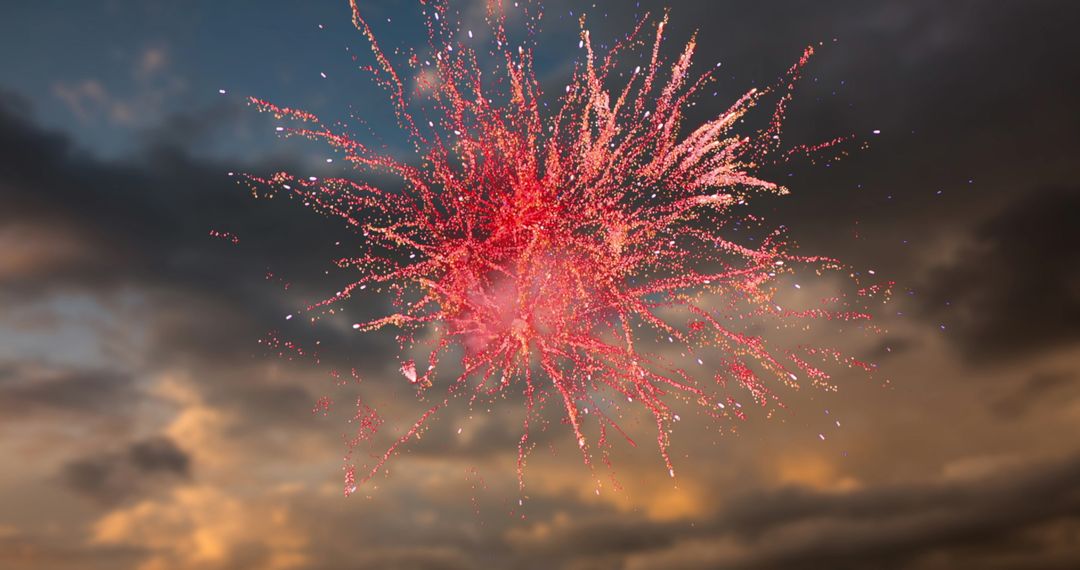 Vivid Red Fireworks Exploding Against Dramatic Sunset Sky