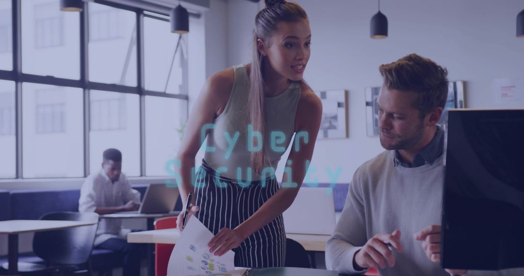 Woman leaning presenting charts to colleague in coworking office with cyber security overlay