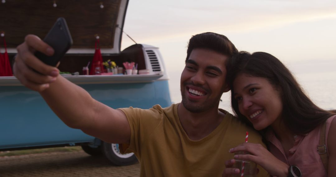 Couple Taking Selfie Near Food Truck at Sunset - Free Images, Stock Photos and Pictures on Pikwizard.com