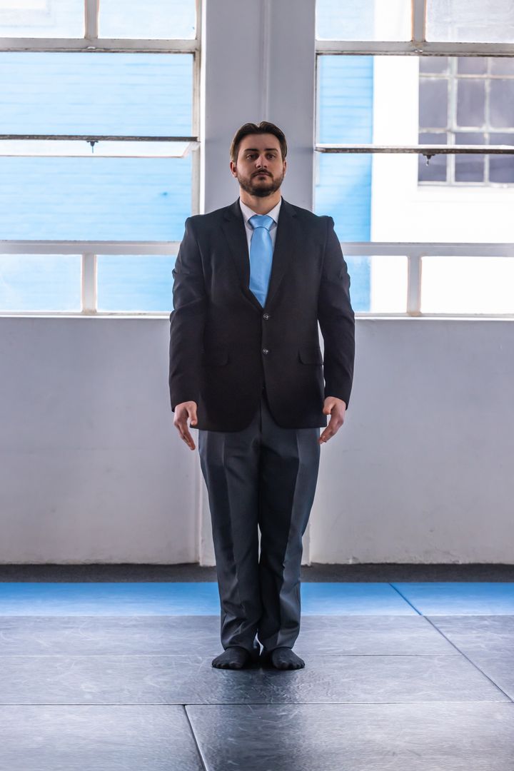 Businessman in Formal Suit Exercises in Training Gym