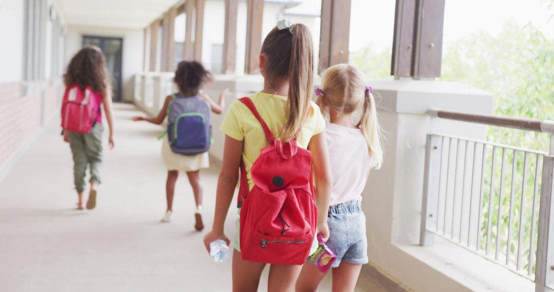 Diverse Group of Young Girls Walking in School Corridor