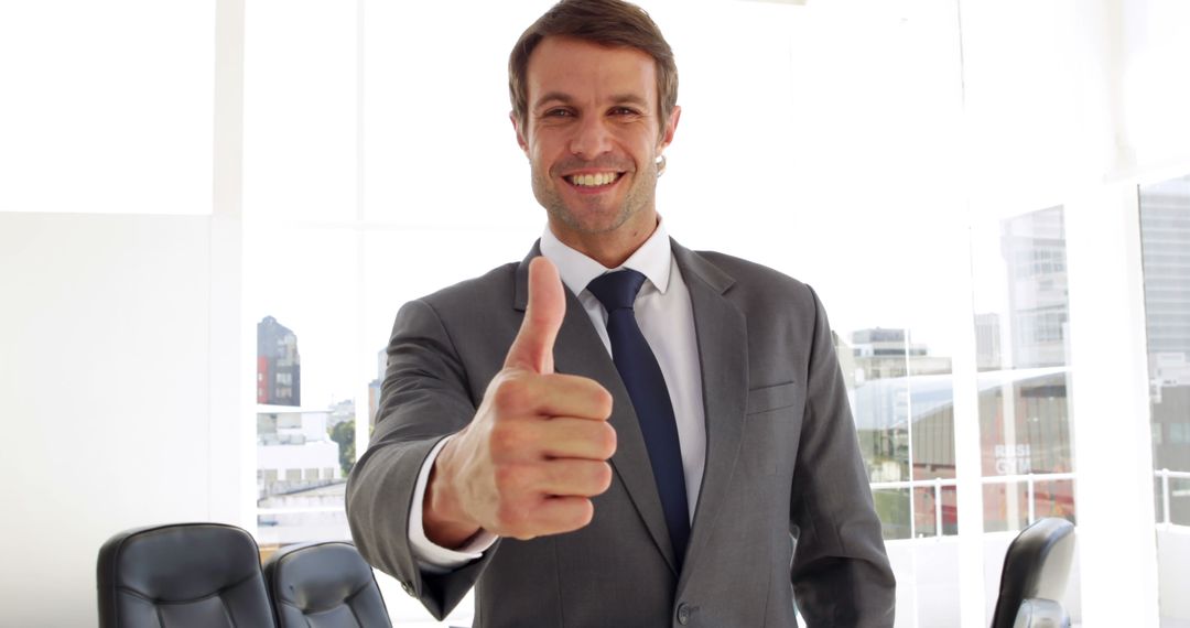 Happy businessman giving thumbs up in his office - Free Images, Stock Photos and Pictures on Pikwizard.com
