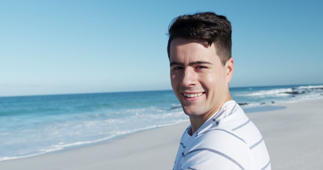 Smiling Man Enjoying Beach on a Sunny Day - Free Images, Stock Photos and Pictures on Pikwizard.com