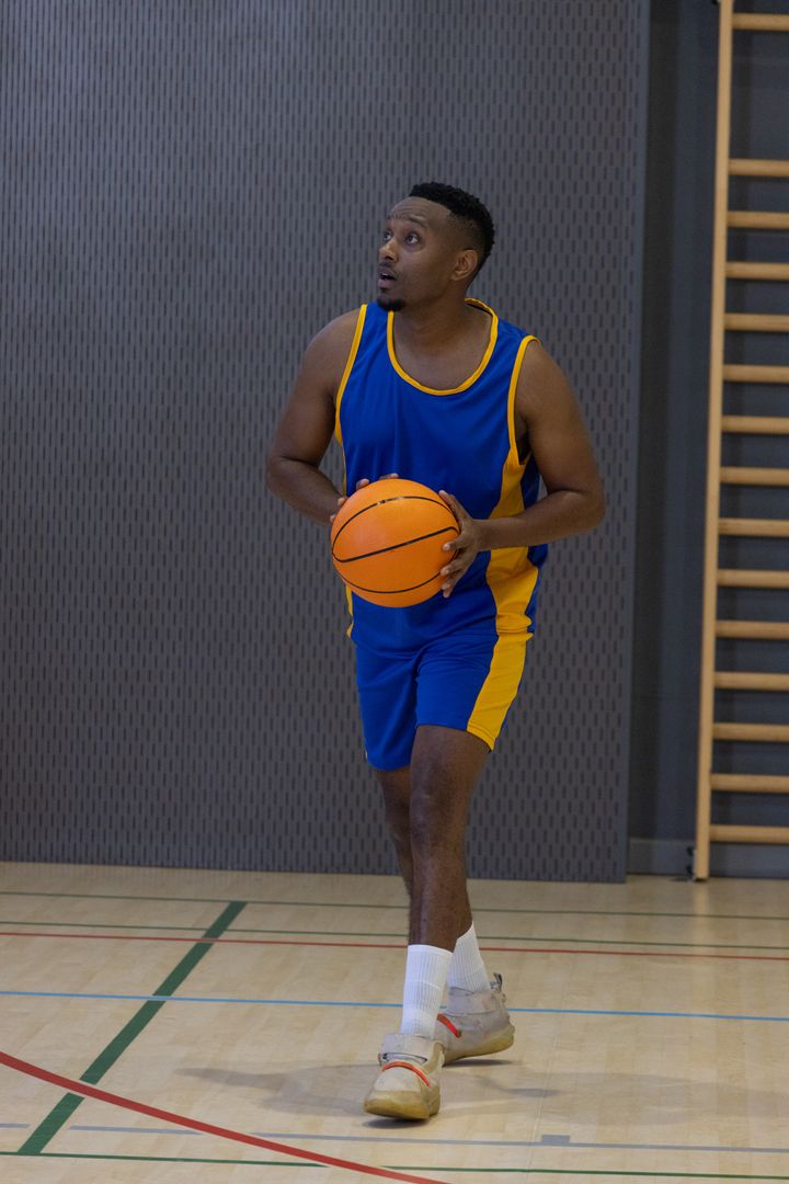 Basketball Player Focused on Success During Indoor Practice