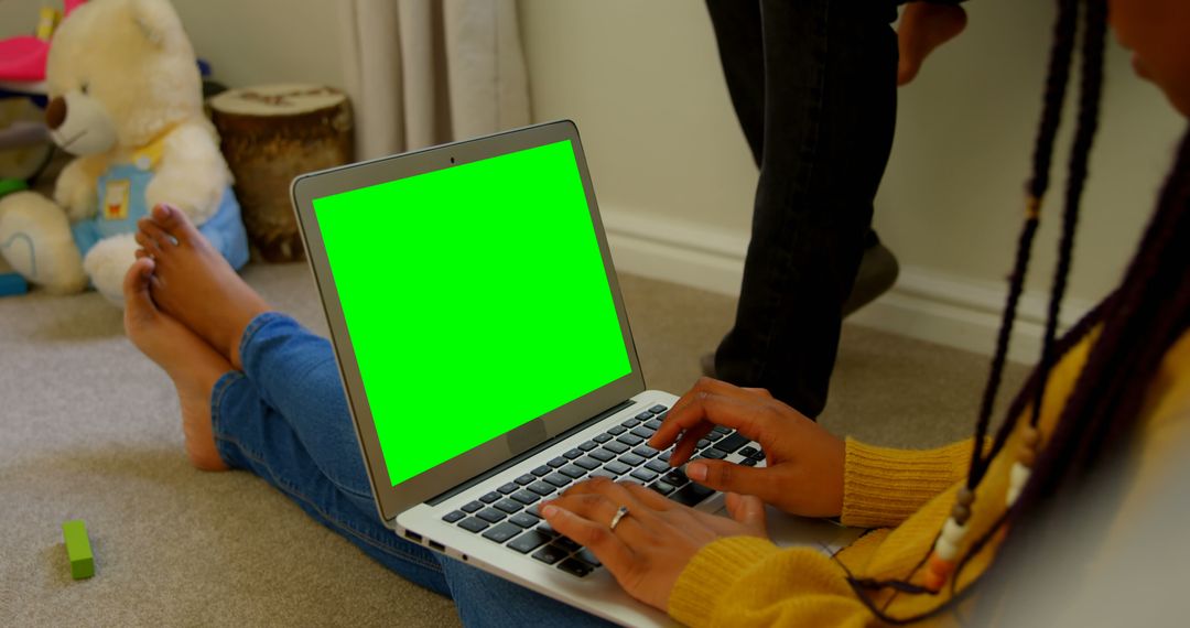 Person Using Laptop with Green Screen in Child's Playroom - Free Images, Stock Photos and Pictures on Pikwizard.com