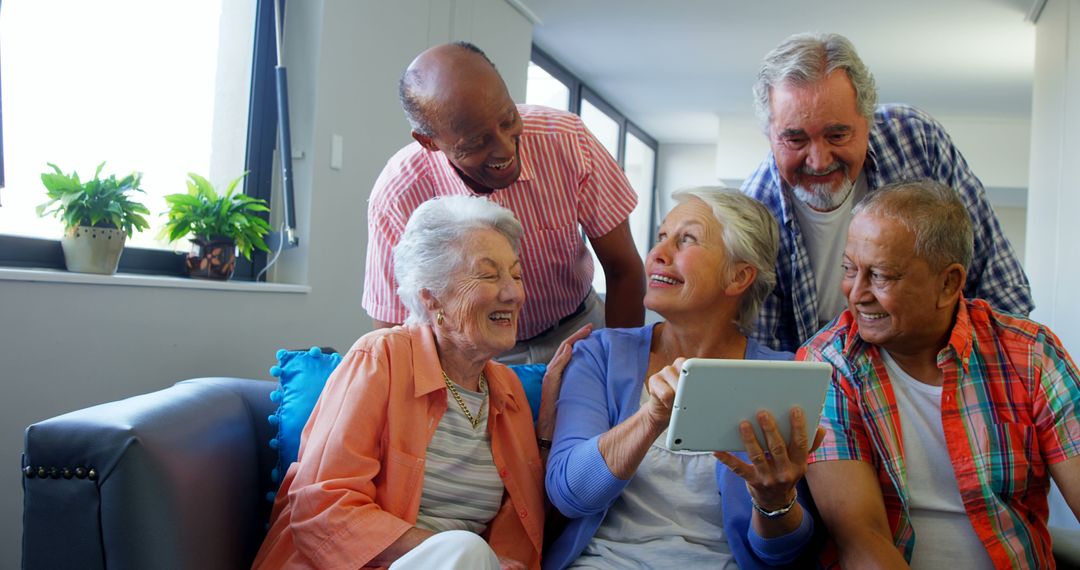 Senior Friends Enjoying Digital Tablet at Home Together - Free Images, Stock Photos and Pictures on Pikwizard.com