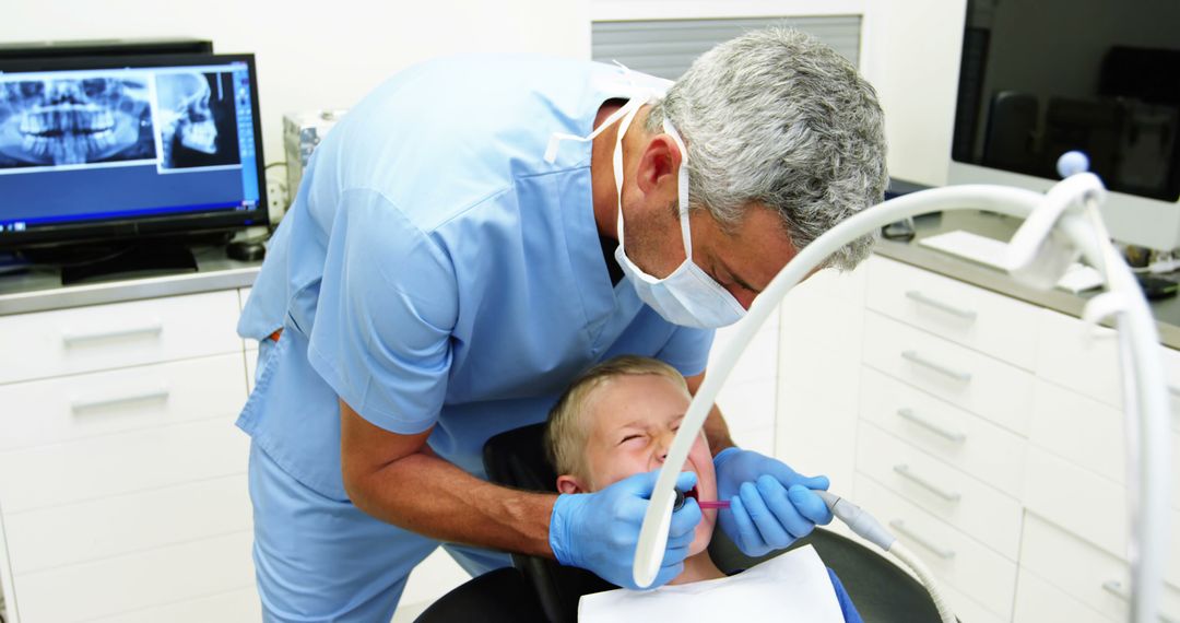 Dentist Treating Young Boy's Teeth in Modern Dental Office - Free Images, Stock Photos and Pictures on Pikwizard.com