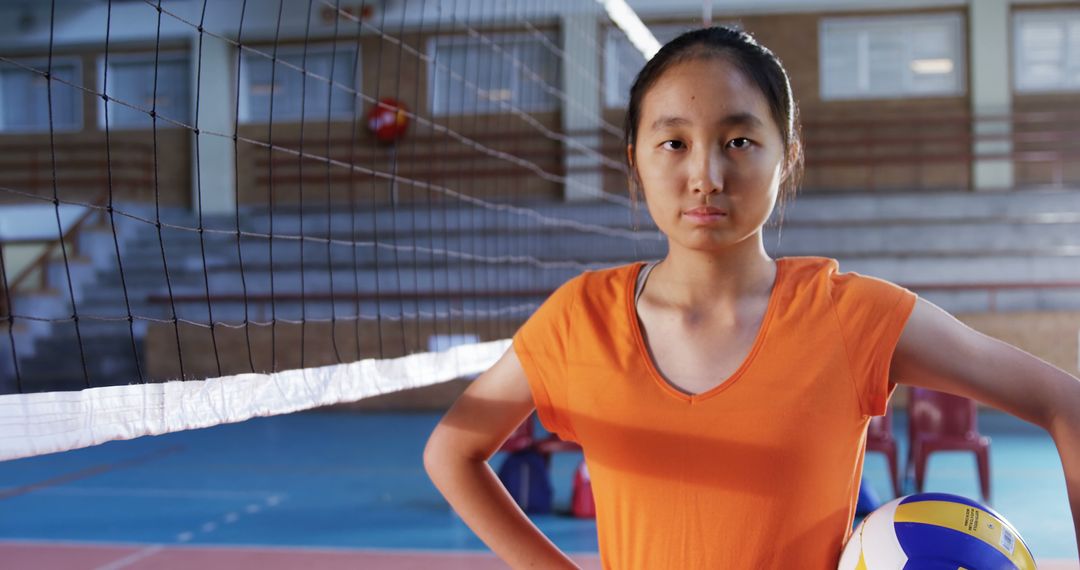 Confident Teenage Girl Holding Volleyball in Gym - Free Images, Stock Photos and Pictures on Pikwizard.com