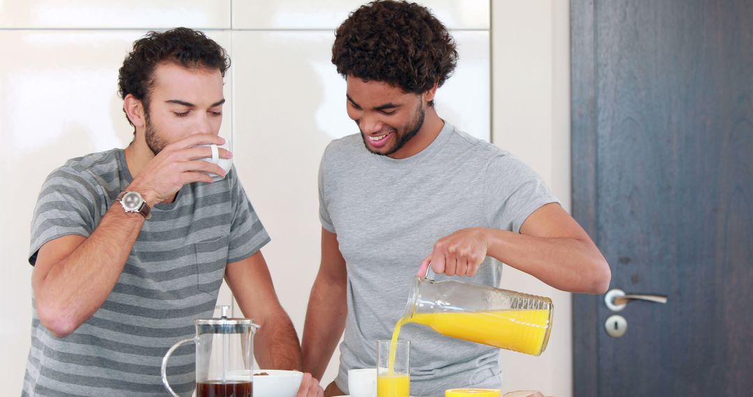 Cheerful Young Men Enjoying Breakfast and Coffee in Modern Kitchen - Free Images, Stock Photos and Pictures on Pikwizard.com