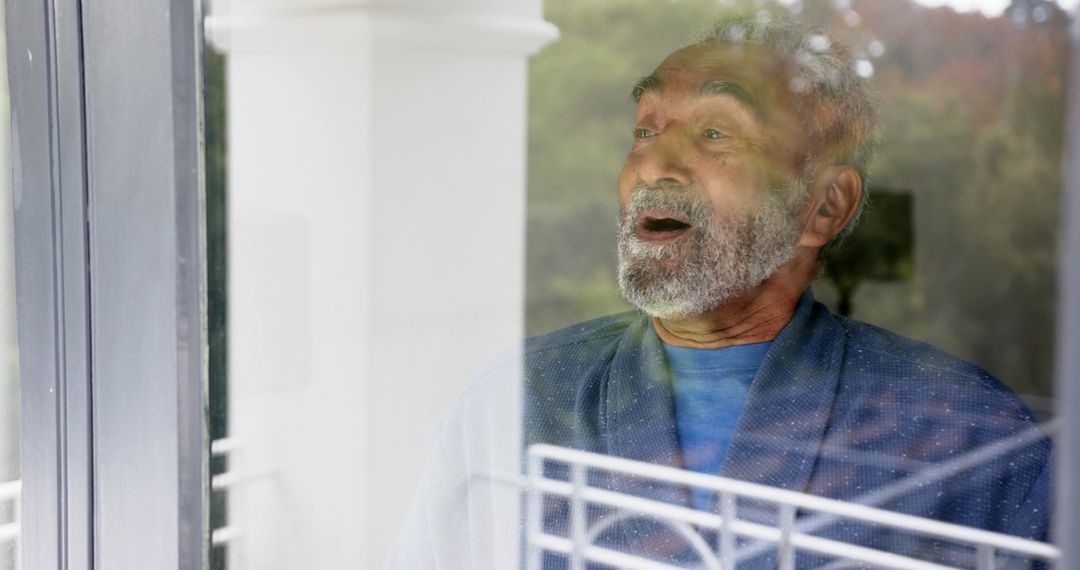 Elderly Man Expressing Surprise While Standing by Window - Free Images, Stock Photos and Pictures on Pikwizard.com