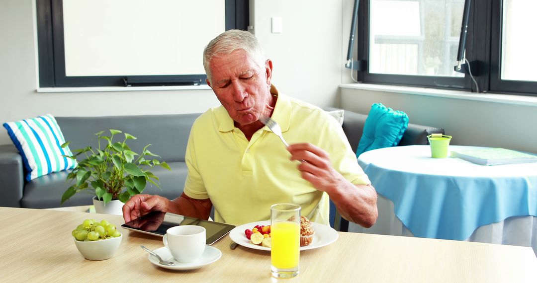 Senior Man Having Breakfast Using Digital Tablet - Free Images, Stock Photos and Pictures on Pikwizard.com