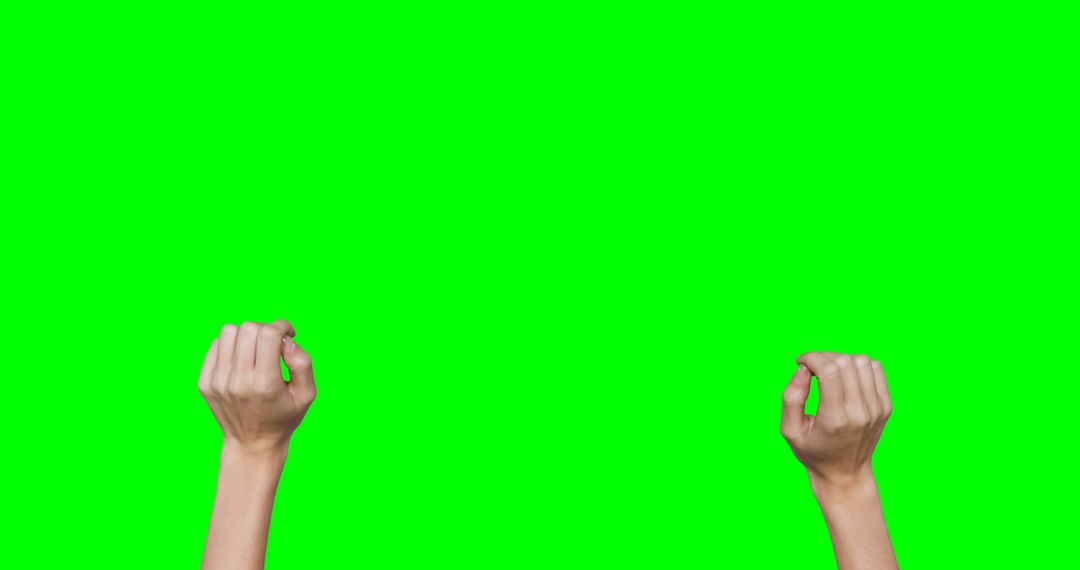 Raised Clenched Hands Against Green Screen - Free Images, Stock Photos and Pictures on Pikwizard.com