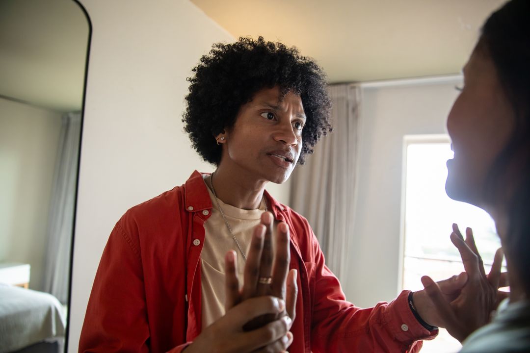 Couple Holding Hands in Emotional Conversation at Home