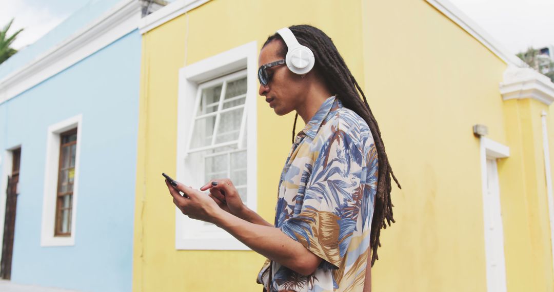 Man with Long Dreadlocks Listening to Music on Smartphone - Free Images, Stock Photos and Pictures on Pikwizard.com