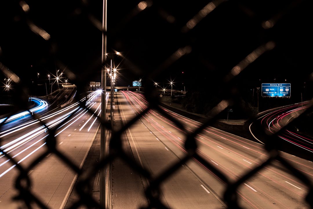 Long exposure highway night traffic through chain-link fence - Free Images, Stock Photos and Pictures on Pikwizard.com