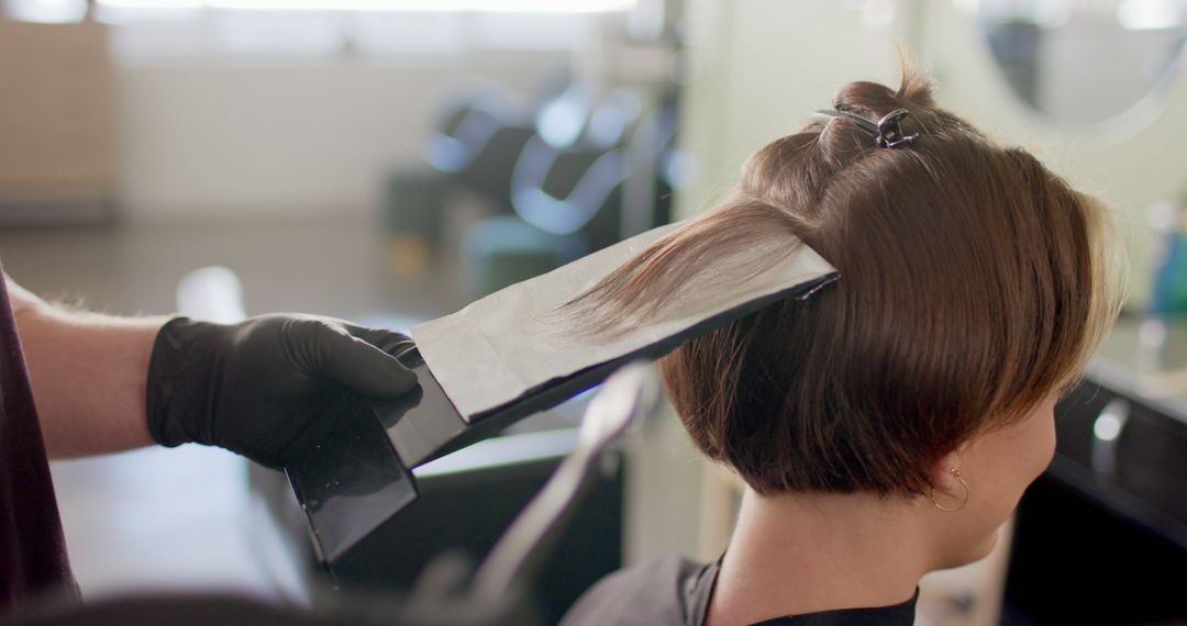 Hairdresser Applying Color to Woman's Hair at Salon - Free Images, Stock Photos and Pictures on Pikwizard.com