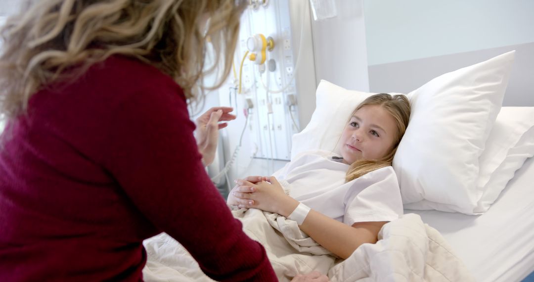 Concerned parent visiting hospitalized child resting in bed - Free Images, Stock Photos and Pictures on Pikwizard.com