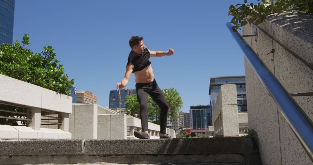 Man Practicing Parkour in Urban Cityscape on Sunny Day - Free Images, Stock Photos and Pictures on Pikwizard.com